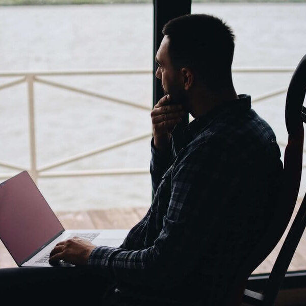 man-on-computer-in-shadows